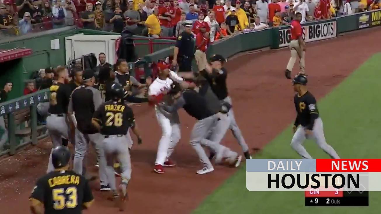 Cincinnati Reds’ Amir Garrett appears to try and fight the entire Pittsburgh Pirates dugout