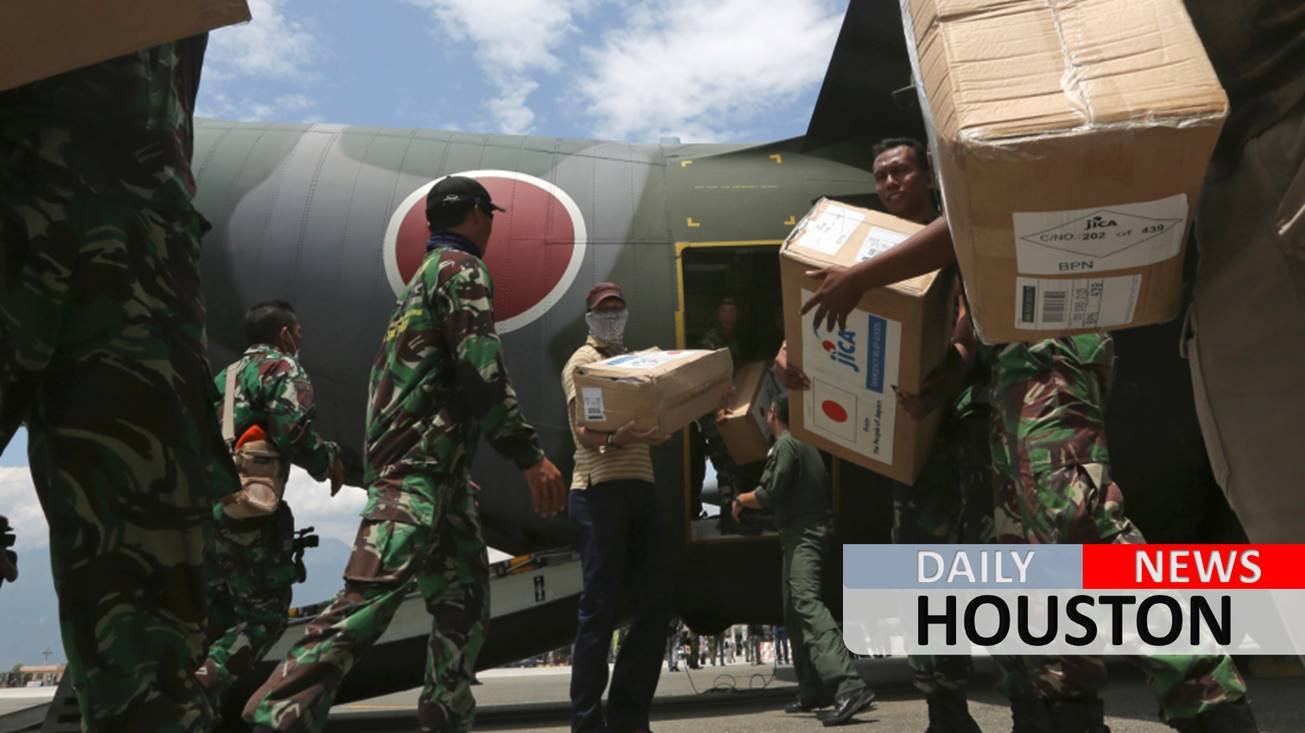 The Latest: Indonesia mulls making quake areas mass graves