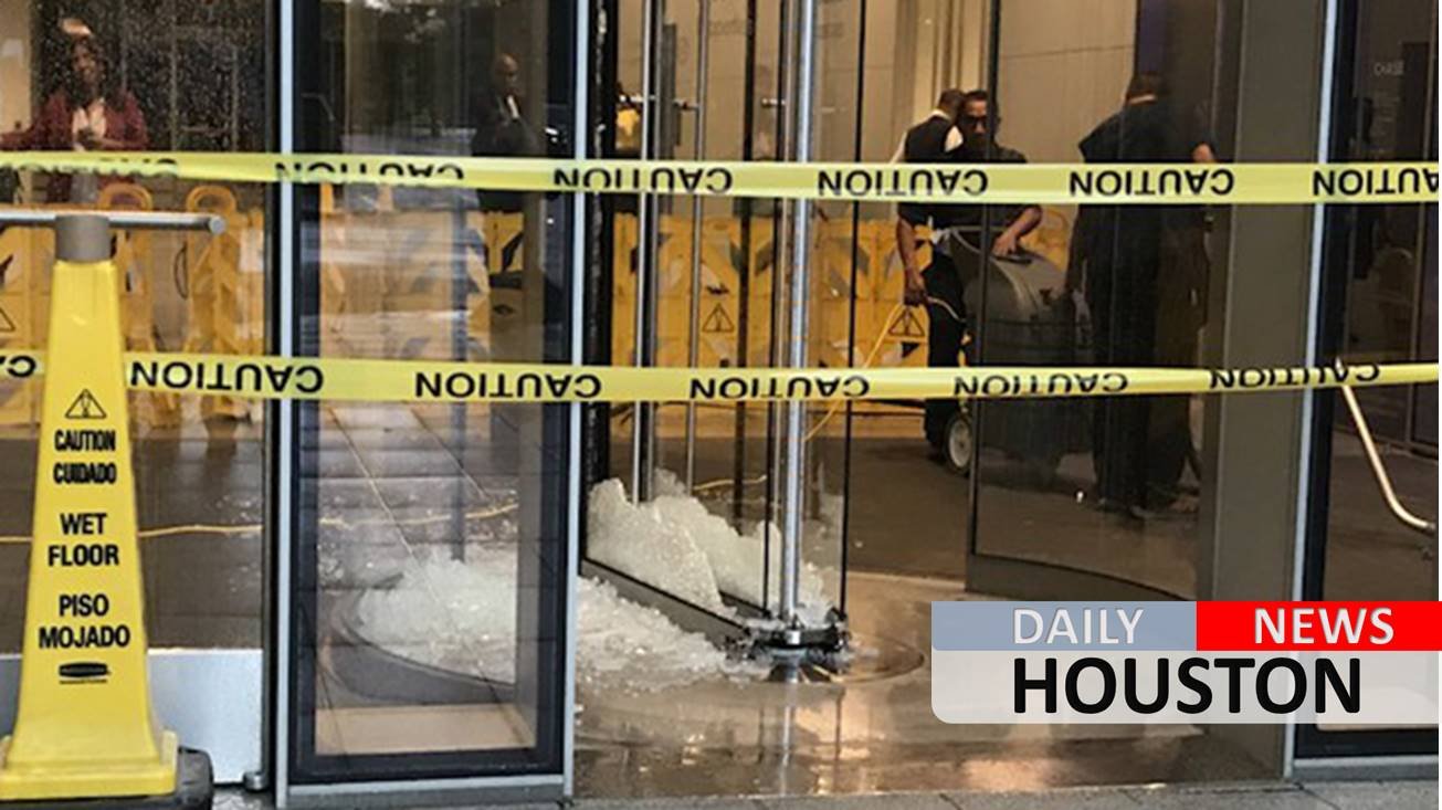 High wind shatters revolving door of building downtown